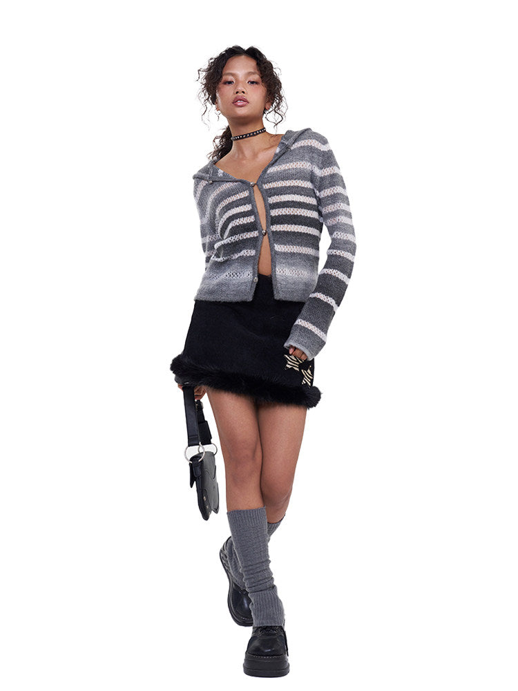 Model wearing the NEXT PASSPORT gray-white gradient hooded knit cardigan with a black mini skirt