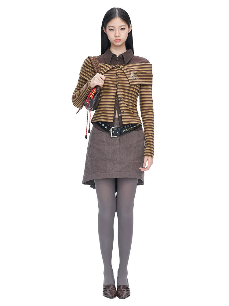 NEXT PASSPORT gray asymmetric cotton mini skirt — front three-quarter modeled view showing the flat waist and asymmetric hem.