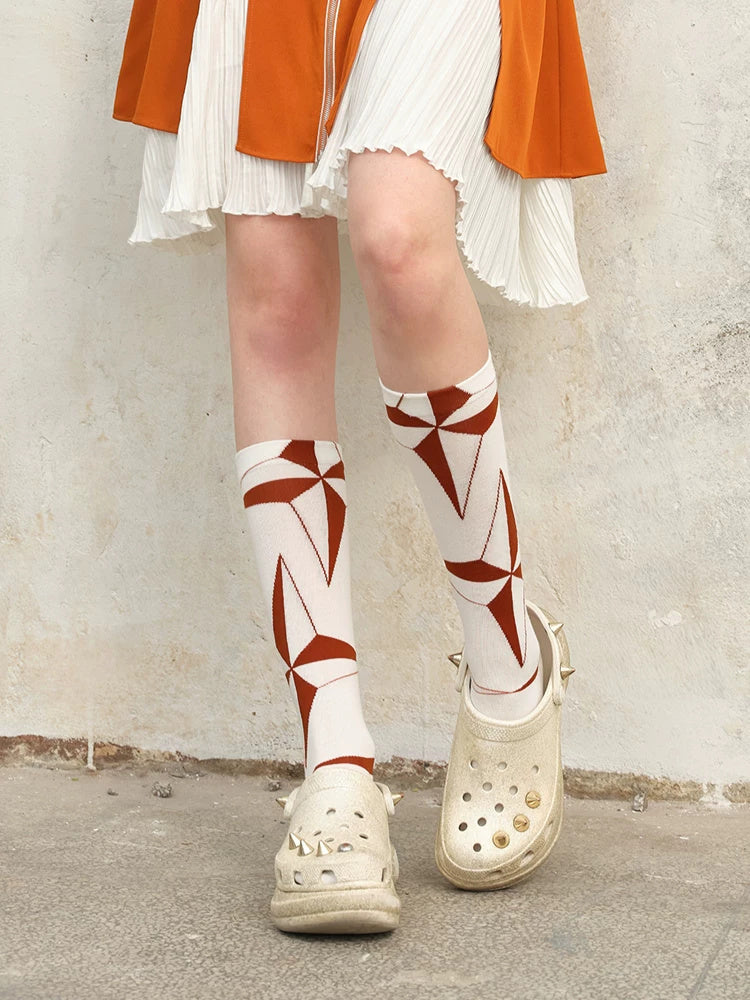 NEXT PASSPORT orange-white argyle lace-up mid-calf socks modeled with an orange dress