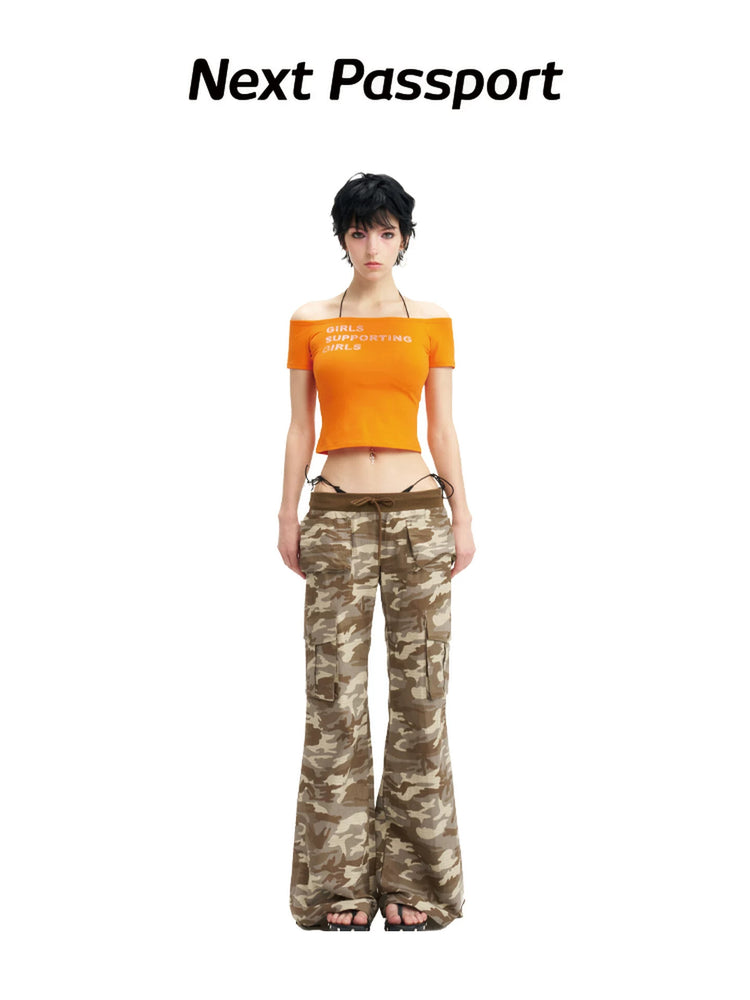 NEXT PASSPORT camouflage ribbed-waist flared pants — full-length front modeled view showing the low-rise ribbed waist and sweeping flared legs.