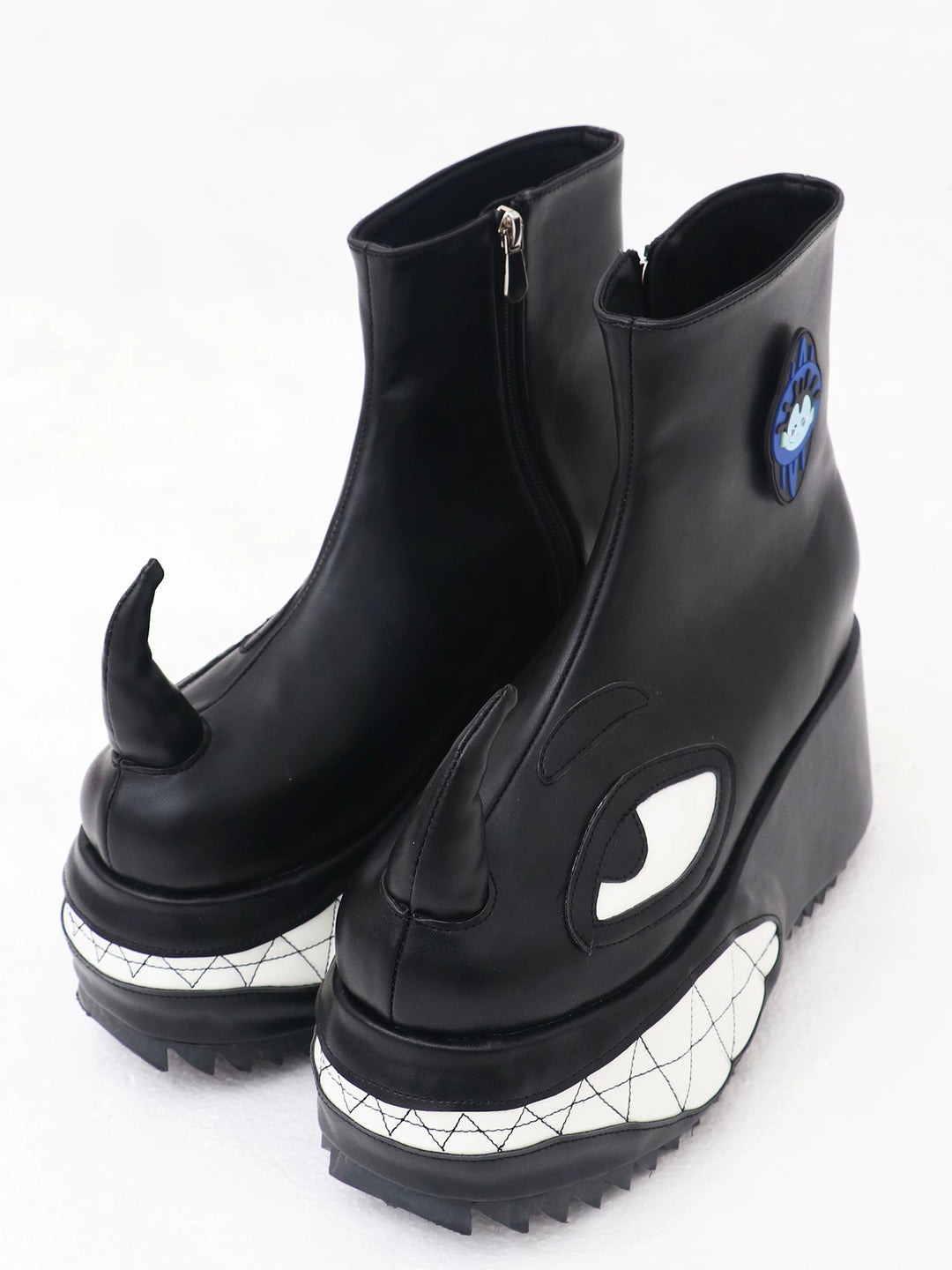 EMBRYO ANGRY horn-toe platform boots — black pair, three-quarter view