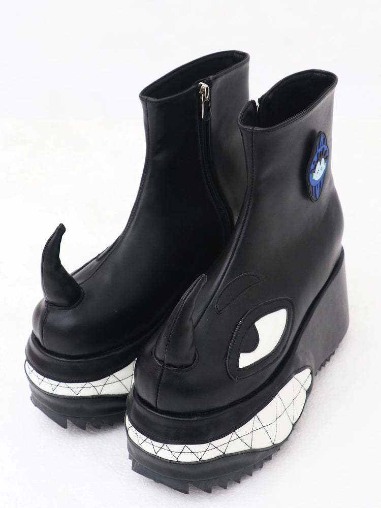 EMBRYO ANGRY horn-toe platform boots — black pair, three-quarter view
