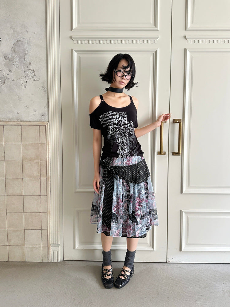 4RE1GN CROSS RIBBON jacquard lace layered skirt in multicolor — full-length front modeled view in a doorway