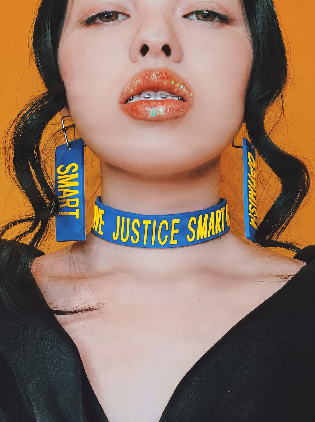 EOH-STUDIO BTBM blue raised-letter silicone choker in a clean, high-resolution neck-focused editorial portrait.