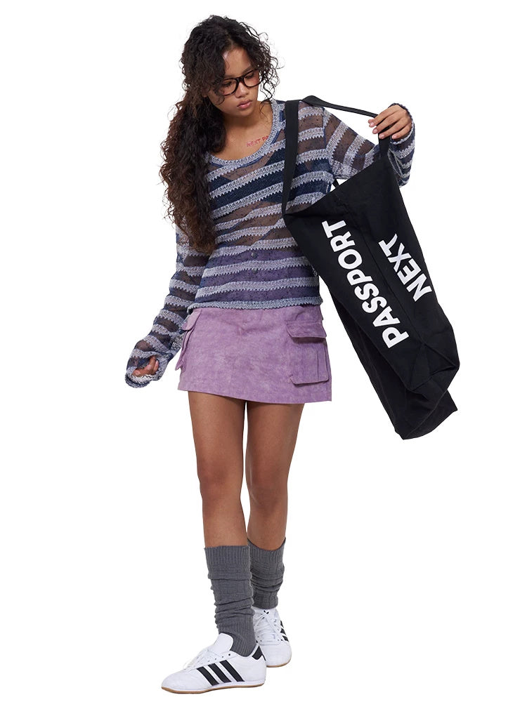 NEXT PASSPORT purple double-waist cargo-pocket mini skirt modeled front with branded tote