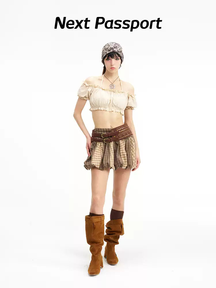 Three-quarter modeled view showing the skirt's gathered plaid panels