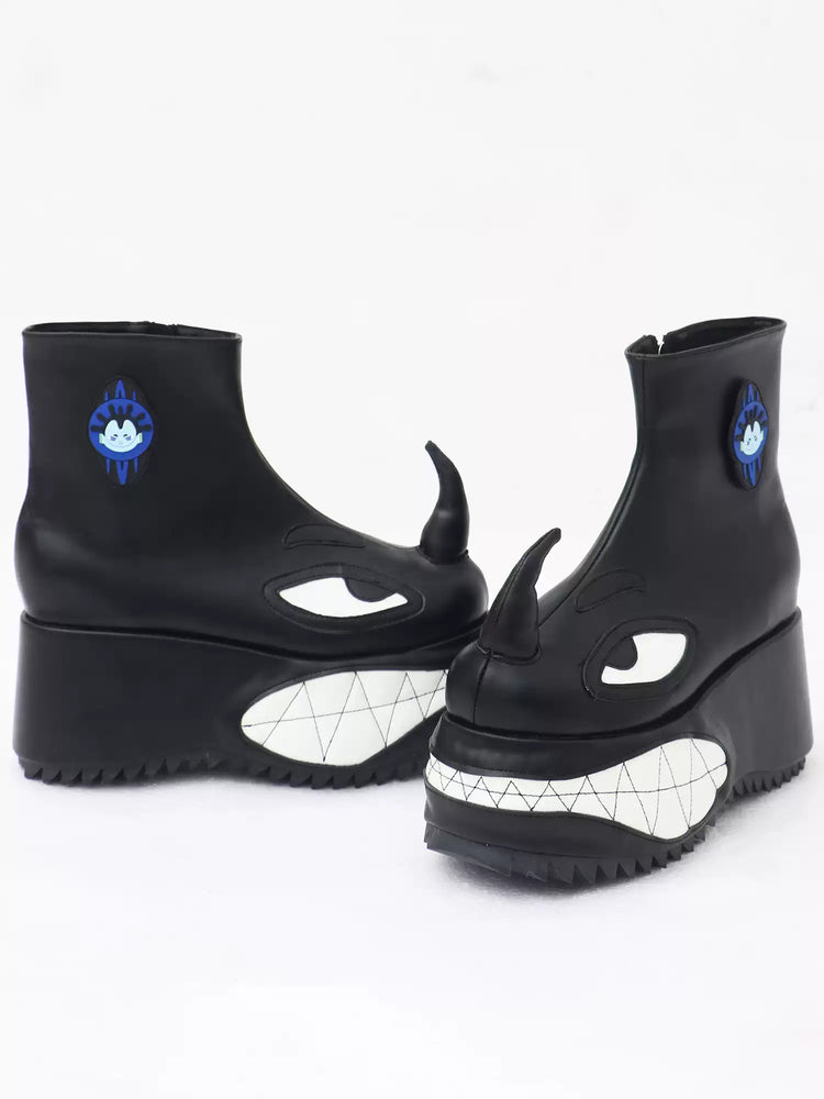 EMBRYO ANGRY horn-toe platform boots — black pair, side and front view