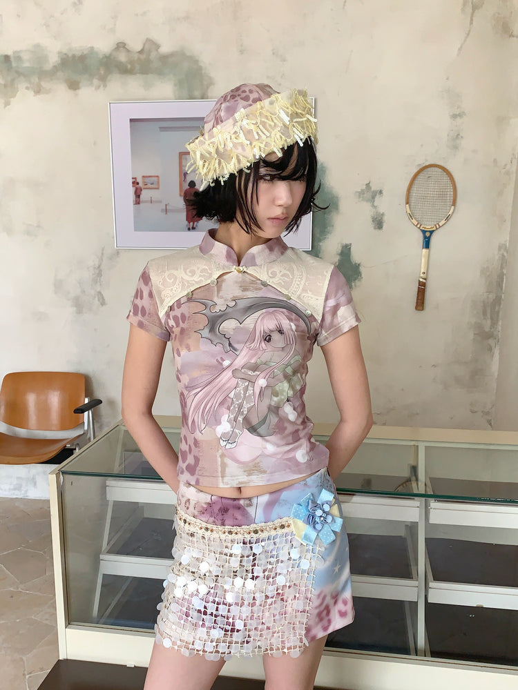 4RE1GN DREAM GARDEN sequin-panel mini skirt in pink multicolor — close front modeled view showing the ribbon flower and sequin panel