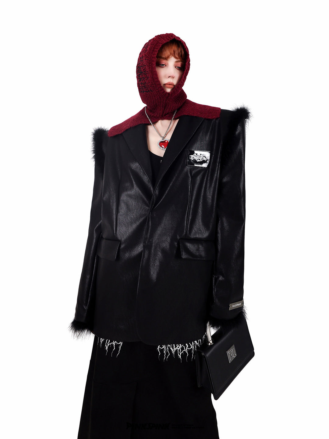 PINKSPINK ELECTRIC THORN embroidered knit balaclava in burgundy — front modeled view with a pointed-shoulder black blazer and bag