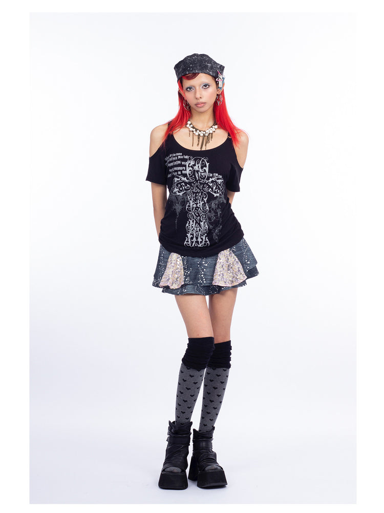 4RE1GN CROSS SCRIPT cold-shoulder tee in black — front modeled view styled with the MYSTIC hat and jeweled skirt