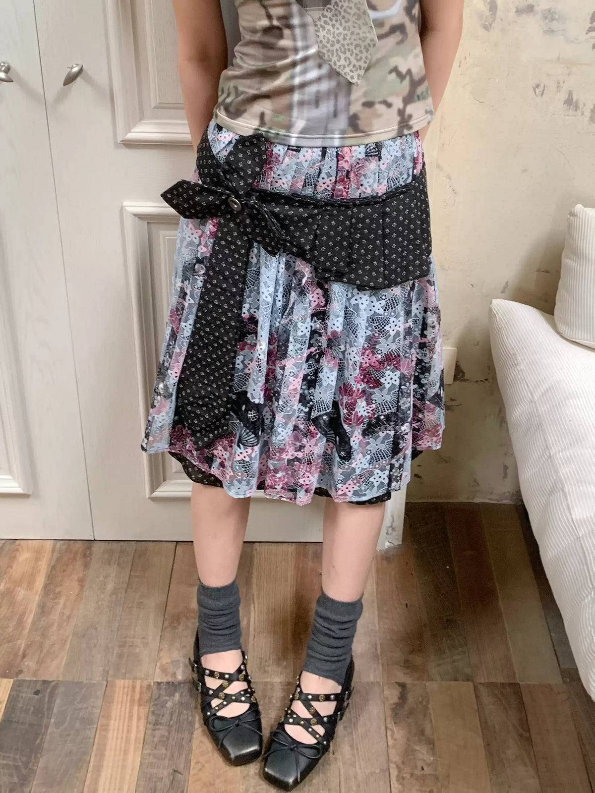 4RE1GN CROSS RIBBON jacquard lace layered skirt in multicolor — close modeled view showing the jacquard bow and printed lace