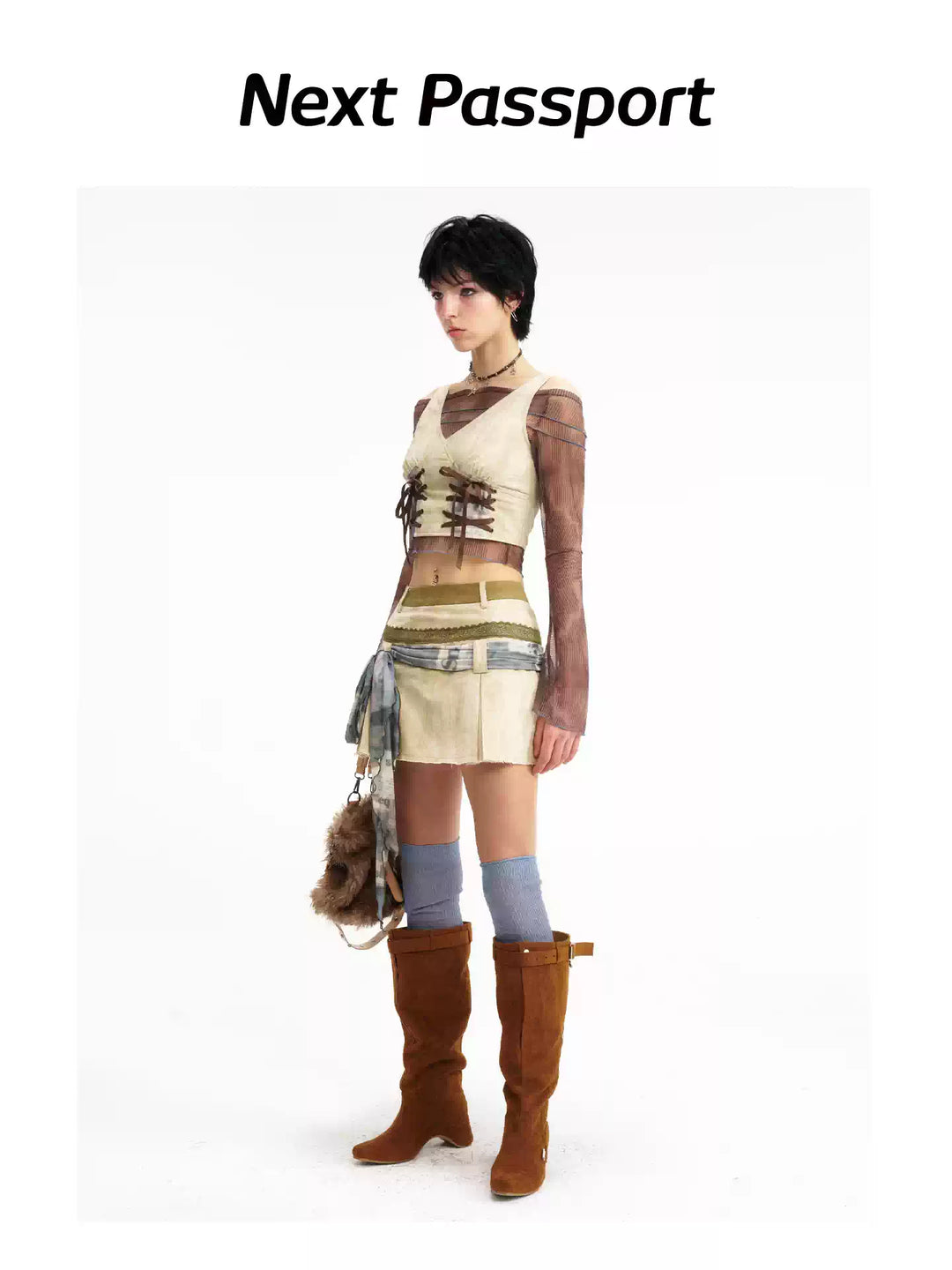 Three-quarter view of the lace-up vest and pleated mini skirt