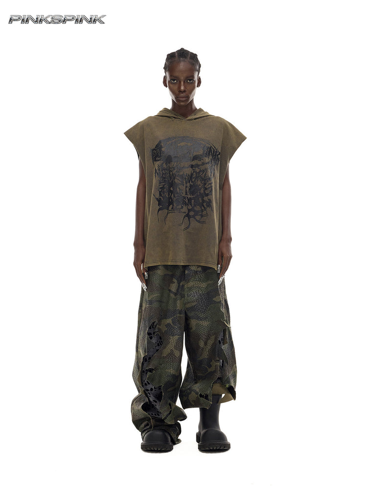 PINKSPINK DOUBLE STACK distressed camouflage wide-leg jeans — front full-length modeled view with an olive sleeveless top