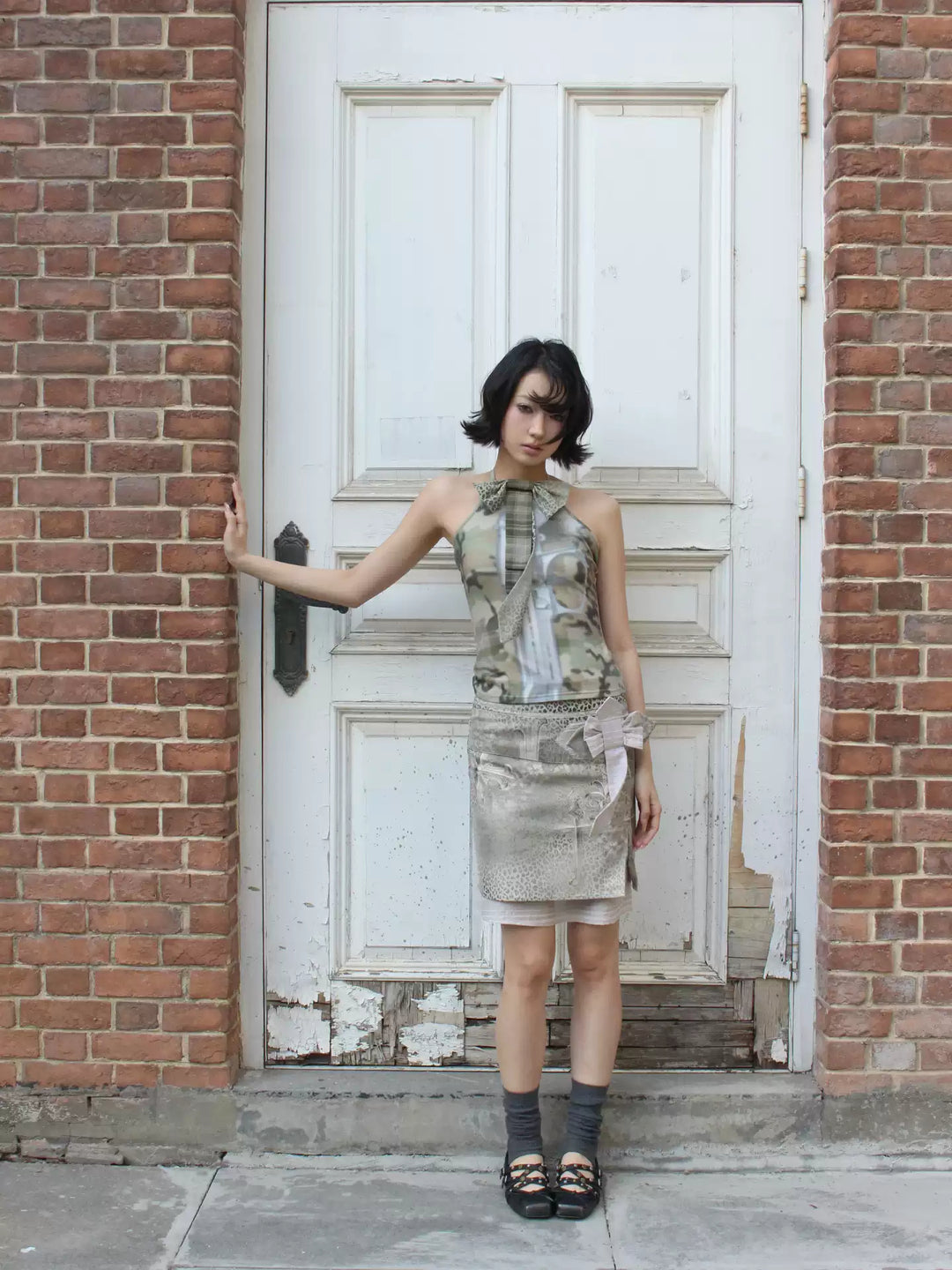 4RE1GN CROSS LEOPARD bow-detail layered skirt in beige multicolor — full-length modeled view with one arm extended
