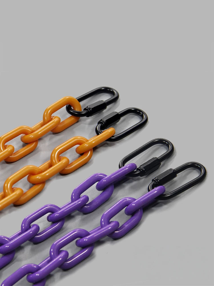 COLLATERAL — orange and purple chain links with black alloy clips, close-up