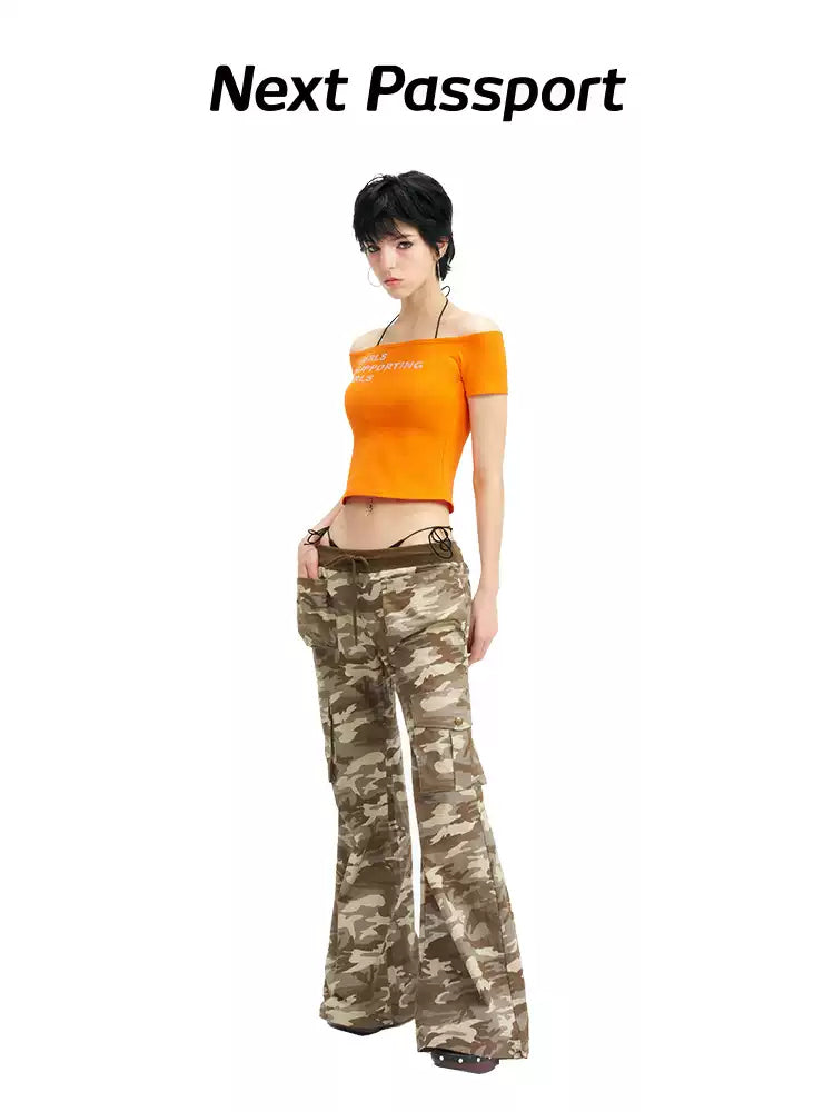 NEXT PASSPORT GIRLS SUPPORTING GIRLS rhinestone off-shoulder crop tee — orange full-body modeled front view.