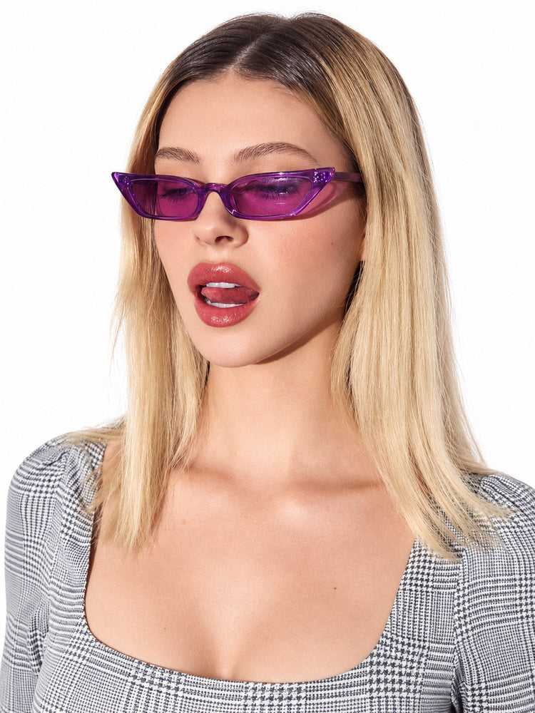 MSPACE WIZARD EYES translucent-purple cat-eye sunglasses worn by a model in a clean studio portrait