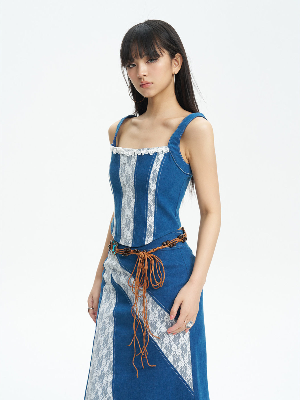 NEXT PASSPORT blue lace-panel denim vest — three-quarter view.