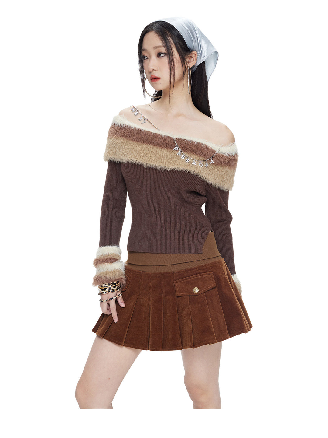 Model wearing the chocolate brown corduroy pleated mini skirt, front view