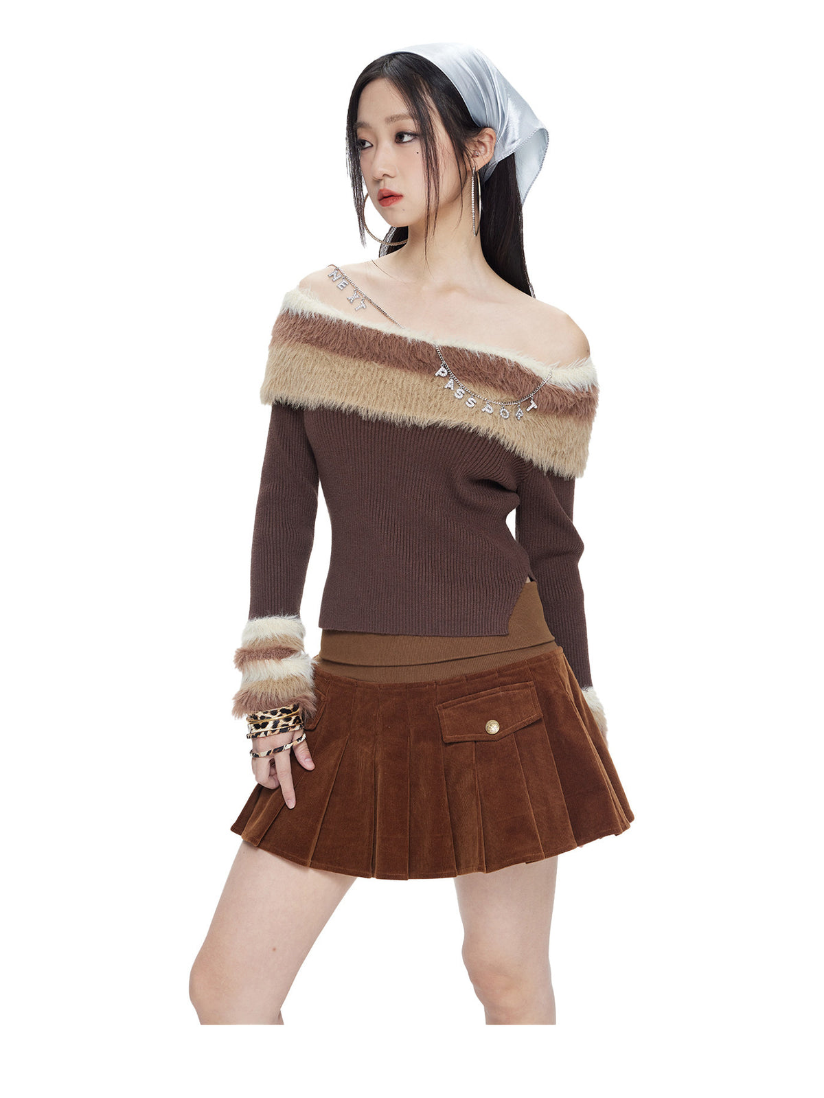 Model wearing the chocolate brown corduroy pleated mini skirt, front view