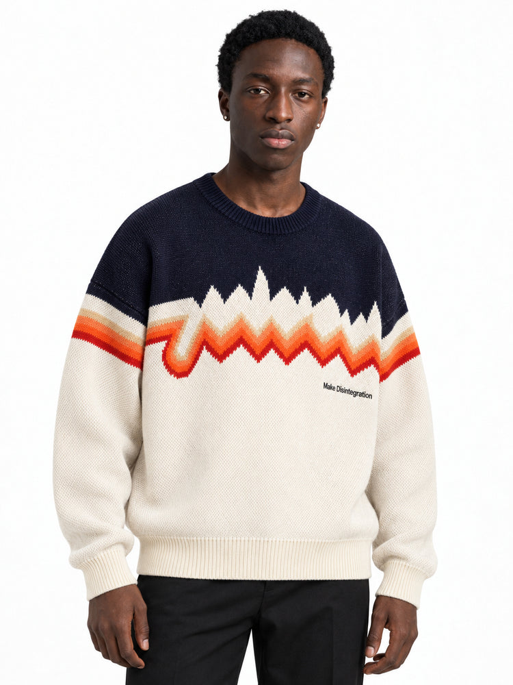Male model wearing the oversized cream and navy zigzag knit sweater, front view.