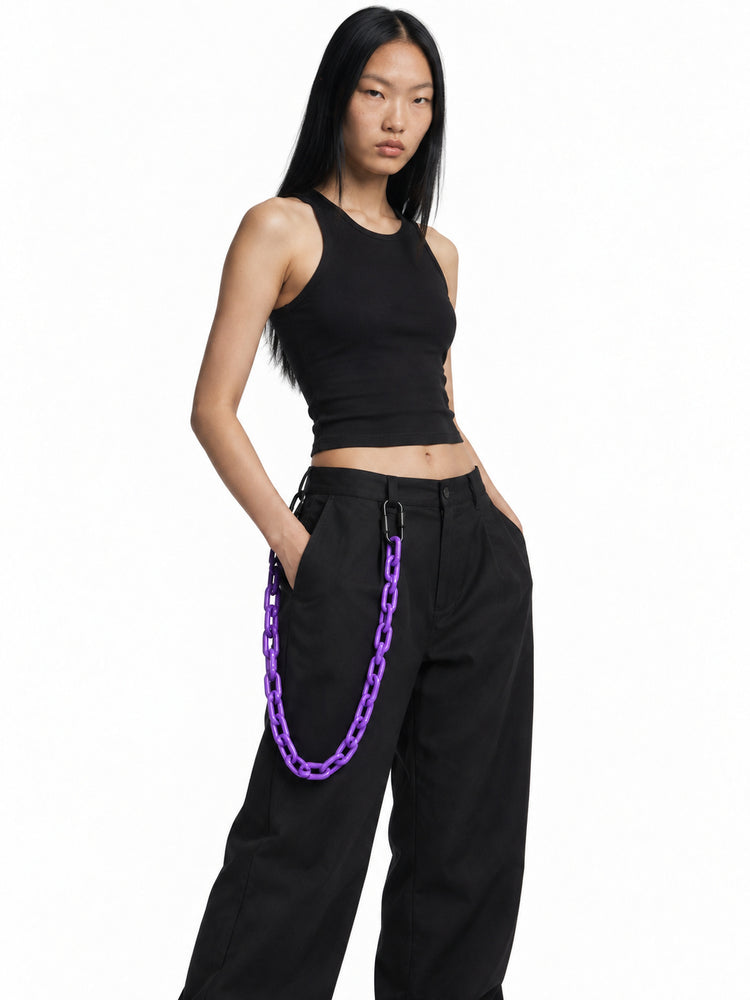 COLLATERAL purple resin trouser chain styled with black trousers on Chell — AI-generated styling image