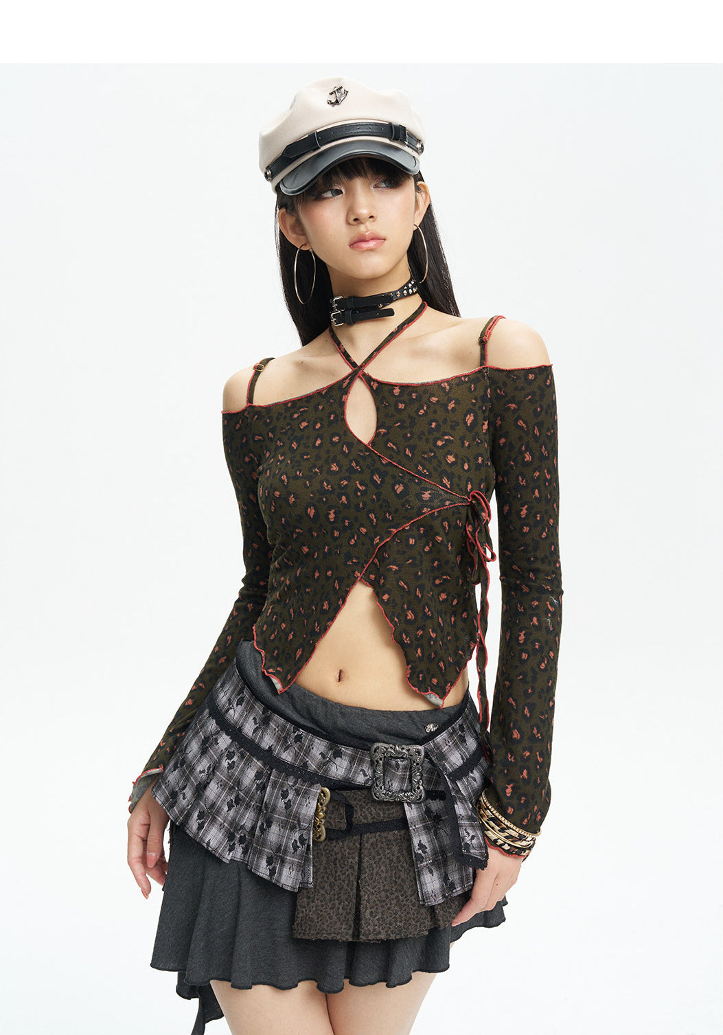 Front studio portrait showing the lace-up neckline and asymmetric hem
