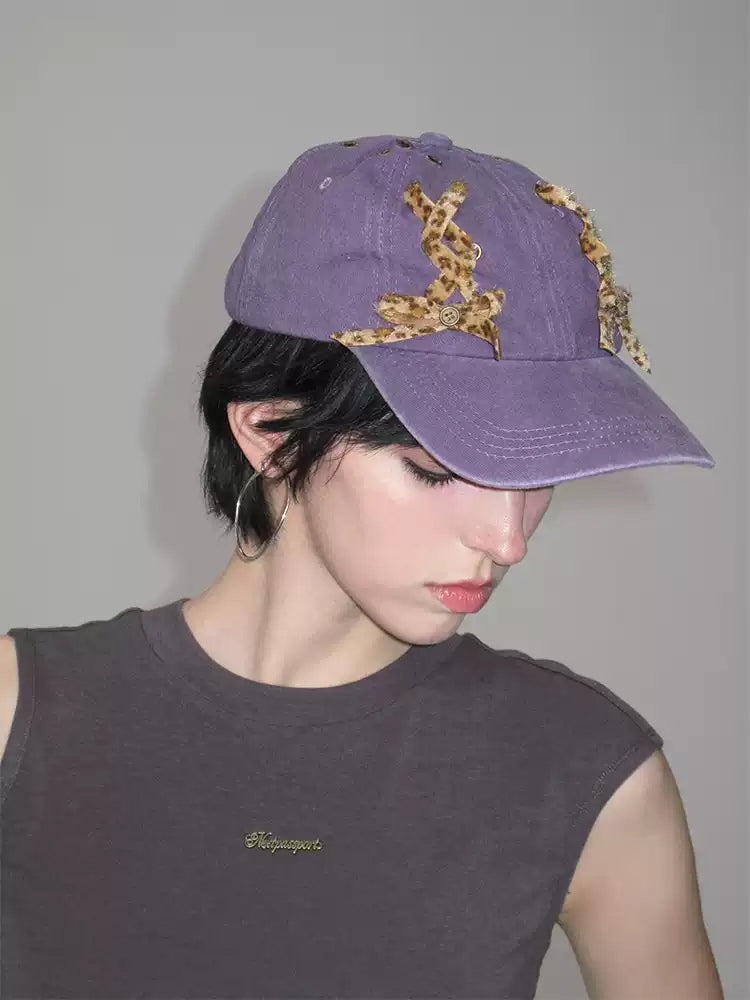 NEXT PASSPORT purple leopard lace-up baseball cap close-up worn view
