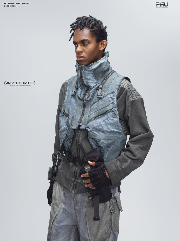 FISSION modular vest in star blue, three-quarter modeled view showing zip pockets and webbing