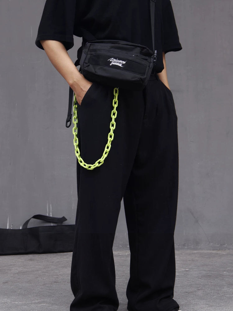 COLLATERAL — green resin trouser chain styled with black trousers