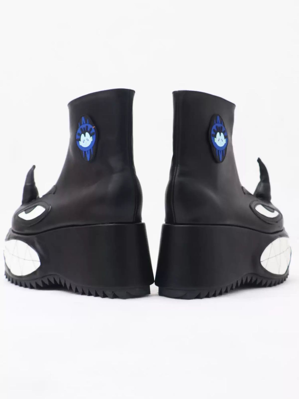 EMBRYO ANGRY horn-toe platform boots — rear view with blue character patches
