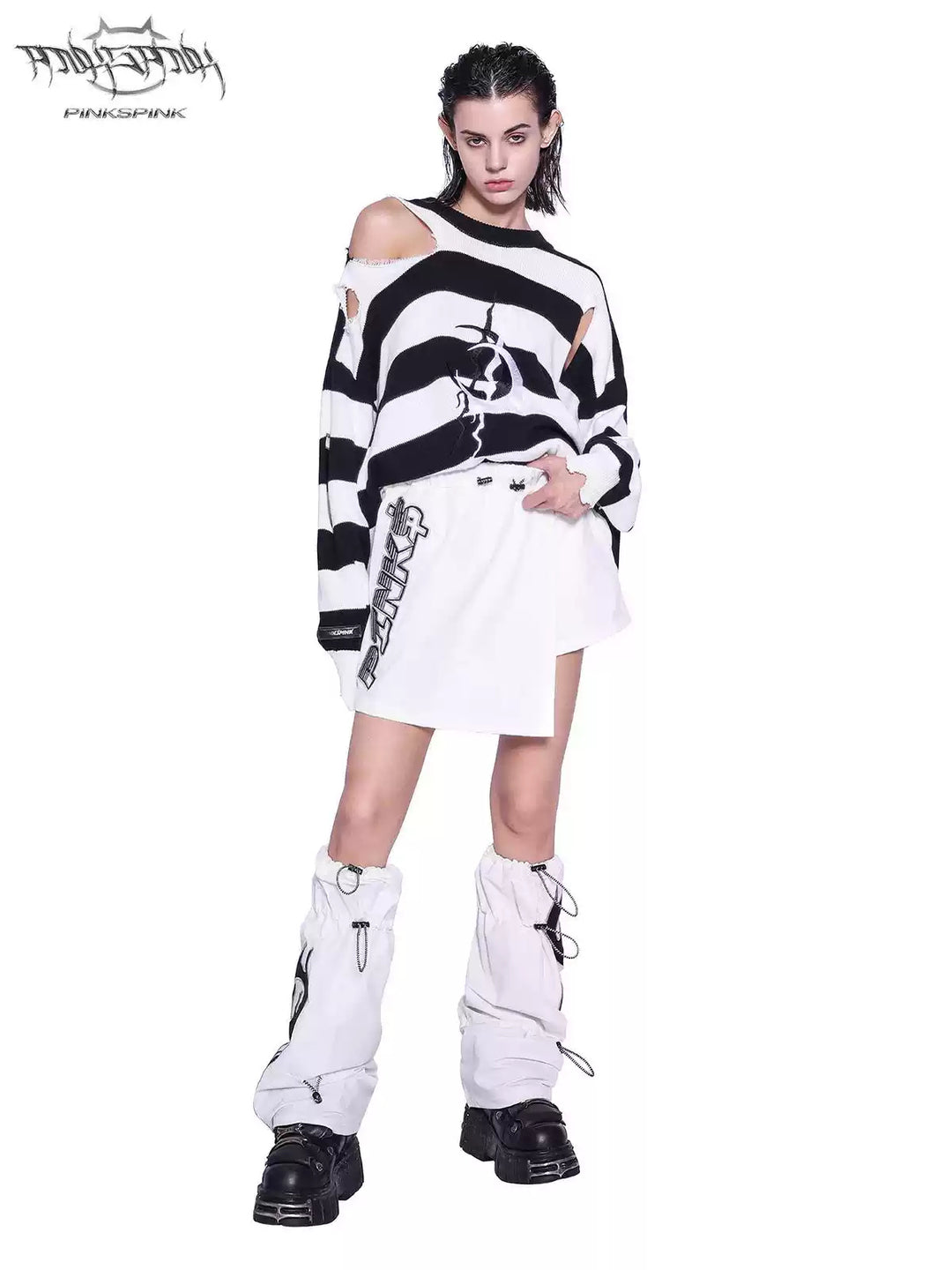 PINKSPINK ELECTRIC MOON distressed striped sweater in BLACK WHITE STRIPE — full-body front view styled with a white skirt and leg warmers.