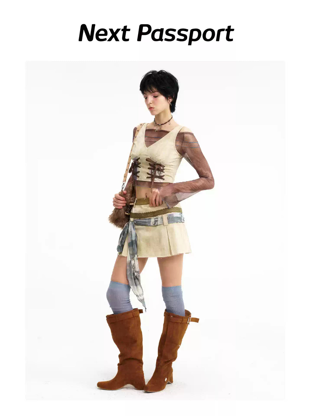 Side-front view showing the cropped vest and layered skirt waistband