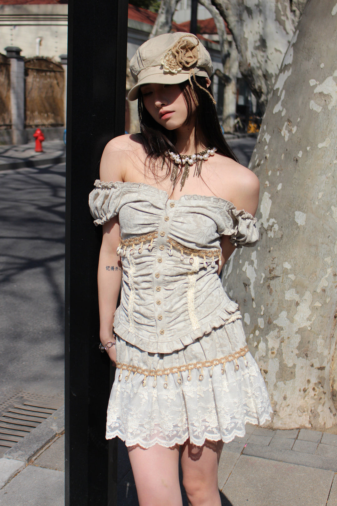 4RE1GN SHELL jacquard blouse and lace skirt separates in ivory — outdoor front modeled view with the blouse worn off the shoulders
