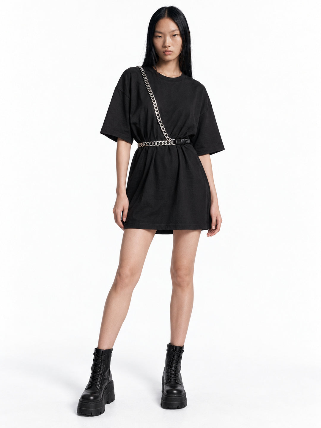 Chell wearing the WRAVEN gathered faux-leather chain belt styled at the waist and across the body.