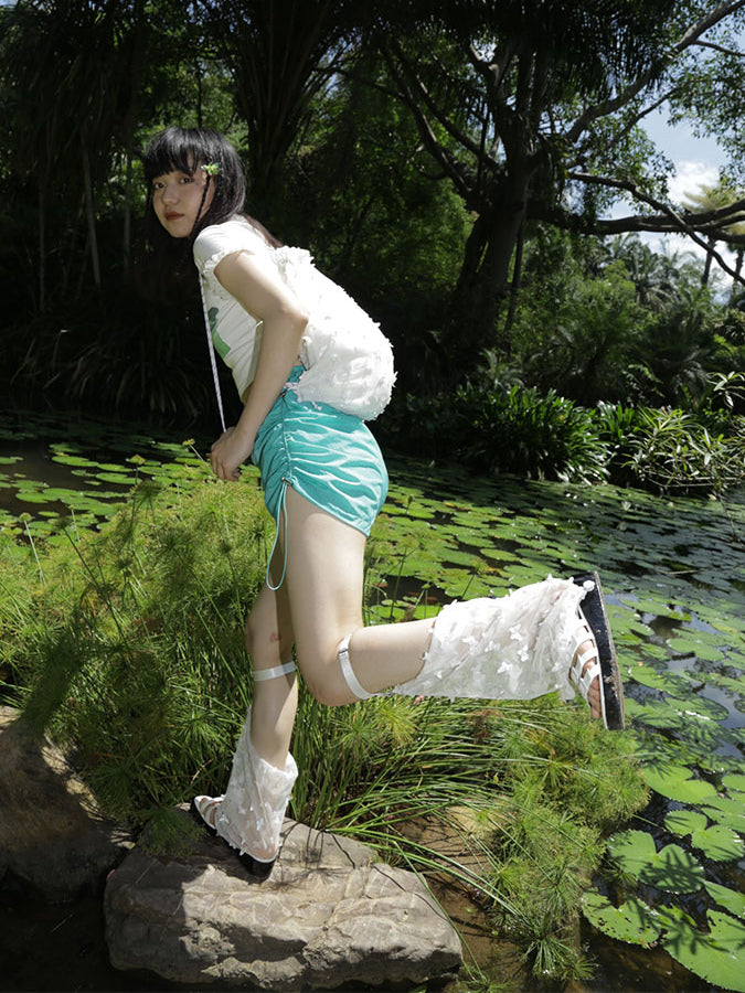 NEXT PASSPORT side-ruched drawstring mini shorts in green, outdoor side view