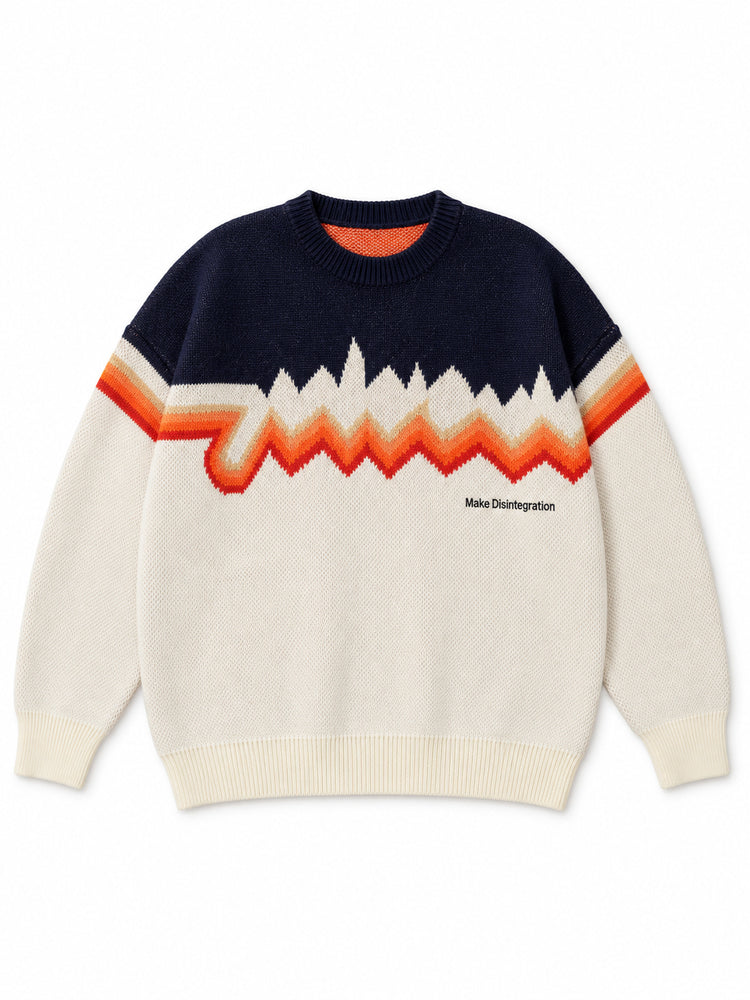 Front flat lay of the Make Disintegration sweater showing the orange zigzag pattern and small chest lettering.