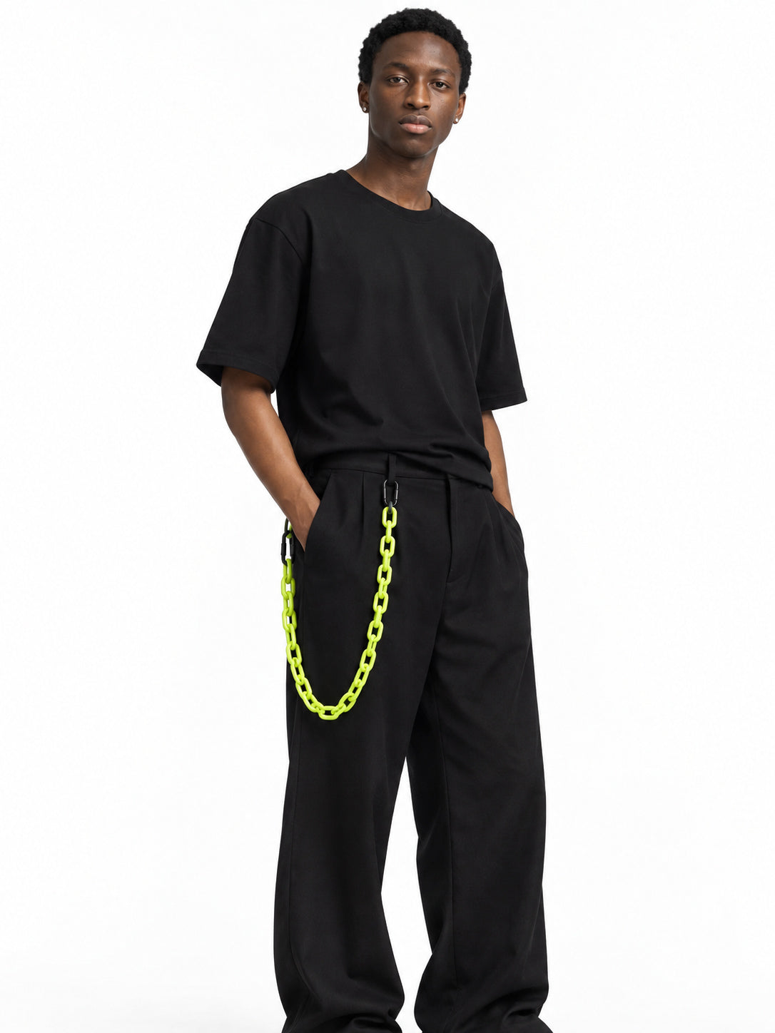 COLLATERAL neon green resin trouser chain styled with black trousers on Derek — AI-generated styling image