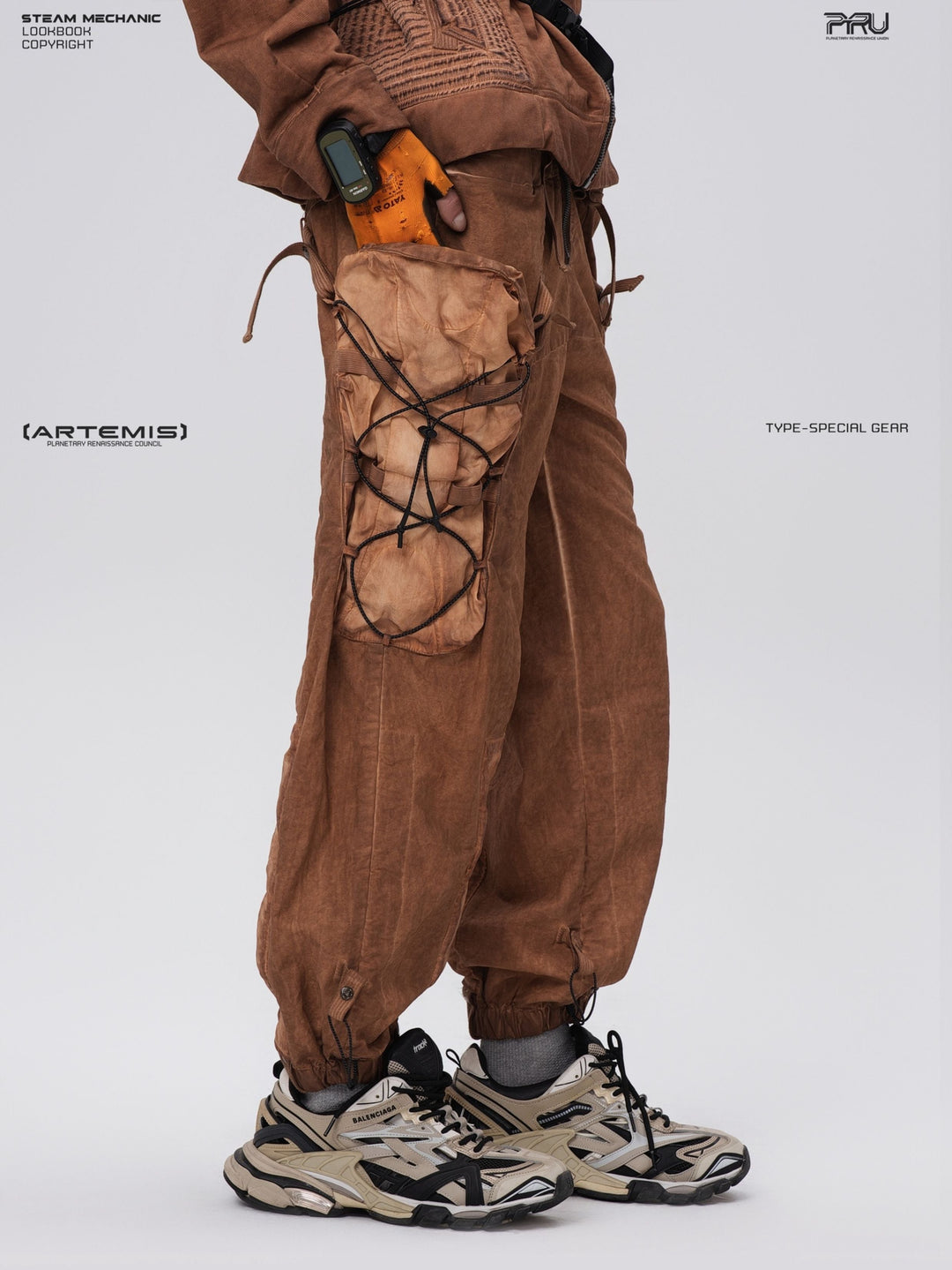 PIONEER detachable waist-pouch cargo pants in corona orange — side modeled close-up showing the laced cargo pocket