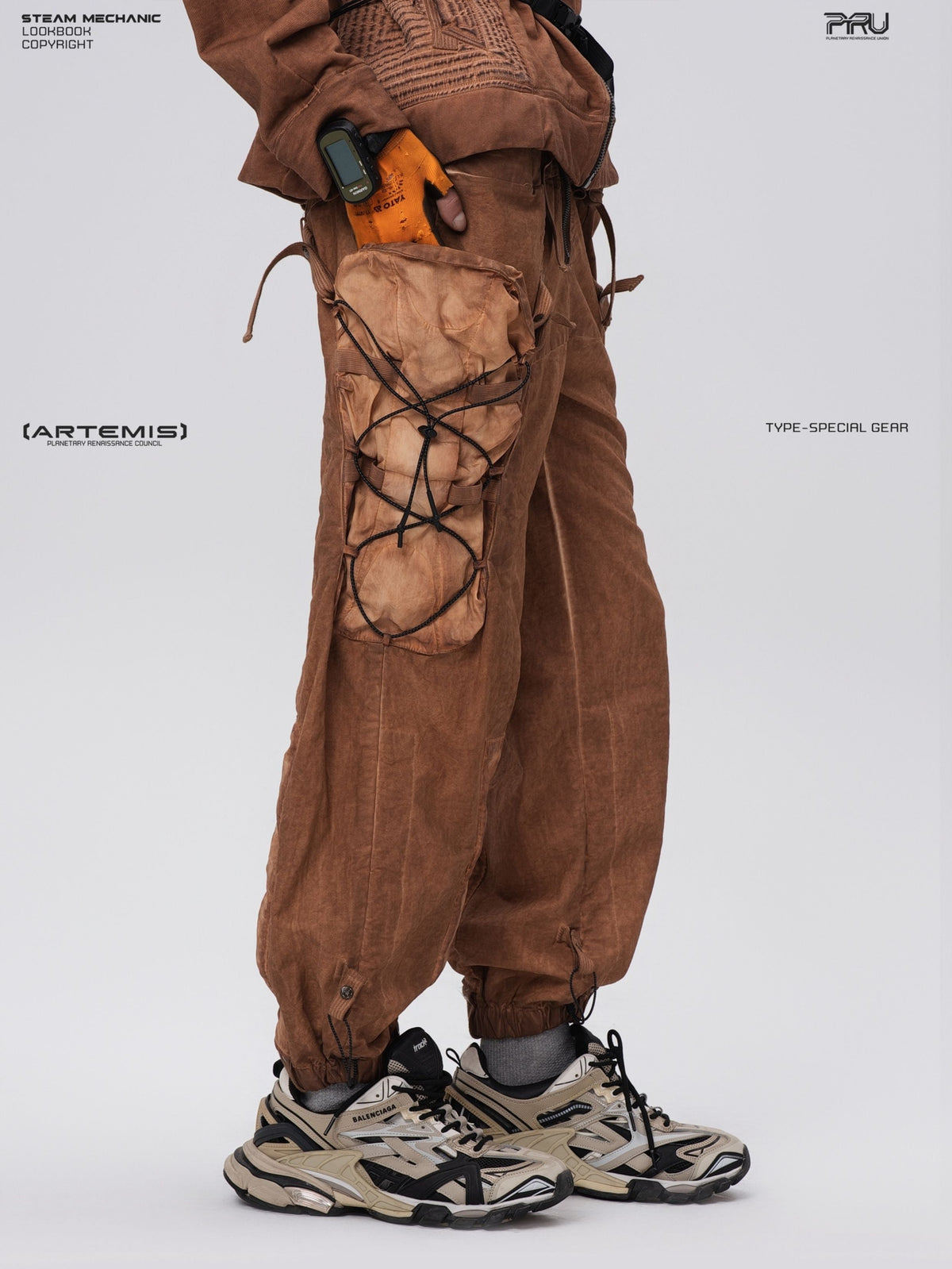 PIONEER detachable waist-pouch cargo pants in corona orange — side modeled close-up showing the laced cargo pocket