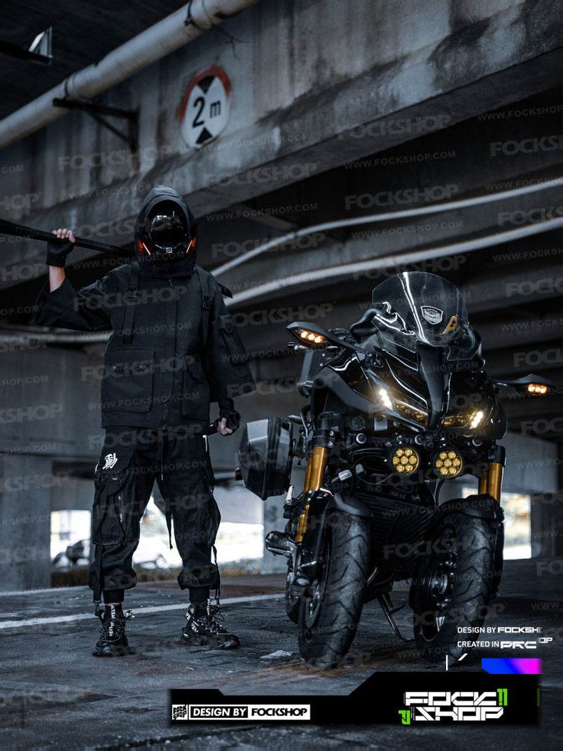 FOCKSHOP VOID black illuminated tactical mask — full-length front modeled view beside a motorcycle