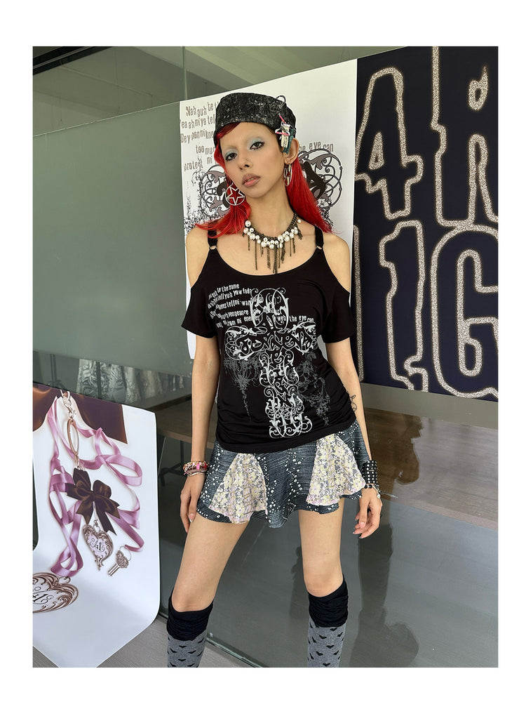 4RE1GN CROSS SCRIPT cold-shoulder tee in black — front modeled view beside the brand display