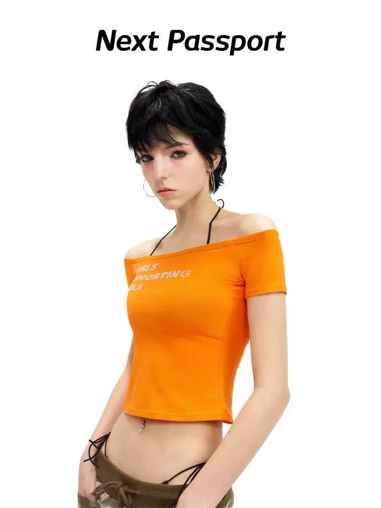 NEXT PASSPORT GIRLS SUPPORTING GIRLS rhinestone off-shoulder crop tee — orange waist-up modeled front view.