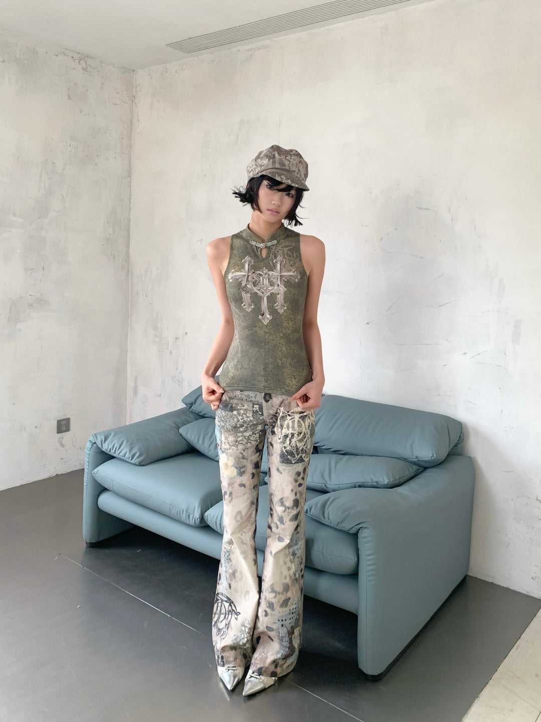 4RE1GN TRIPLE CROSS mandarin sleeveless top in olive green — three-quarter modeled view showing the mandarin collar