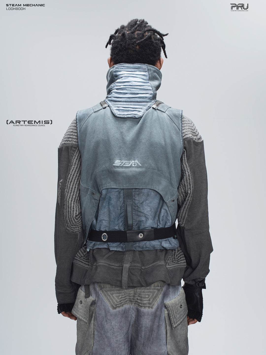 FISSION modular vest in star blue, back modeled view showing the pleated collar and rear pouch