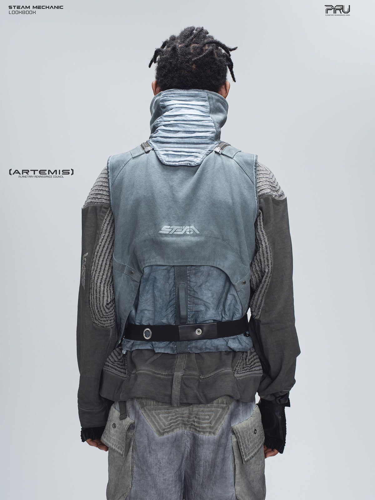FISSION modular vest in star blue, back modeled view showing the pleated collar and rear pouch