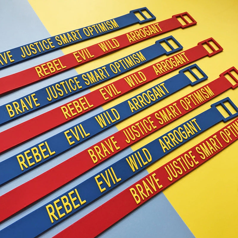 EOH-STUDIO BTBM red and blue BRAVE and EVIL silicone straps, diagonal product arrangement.