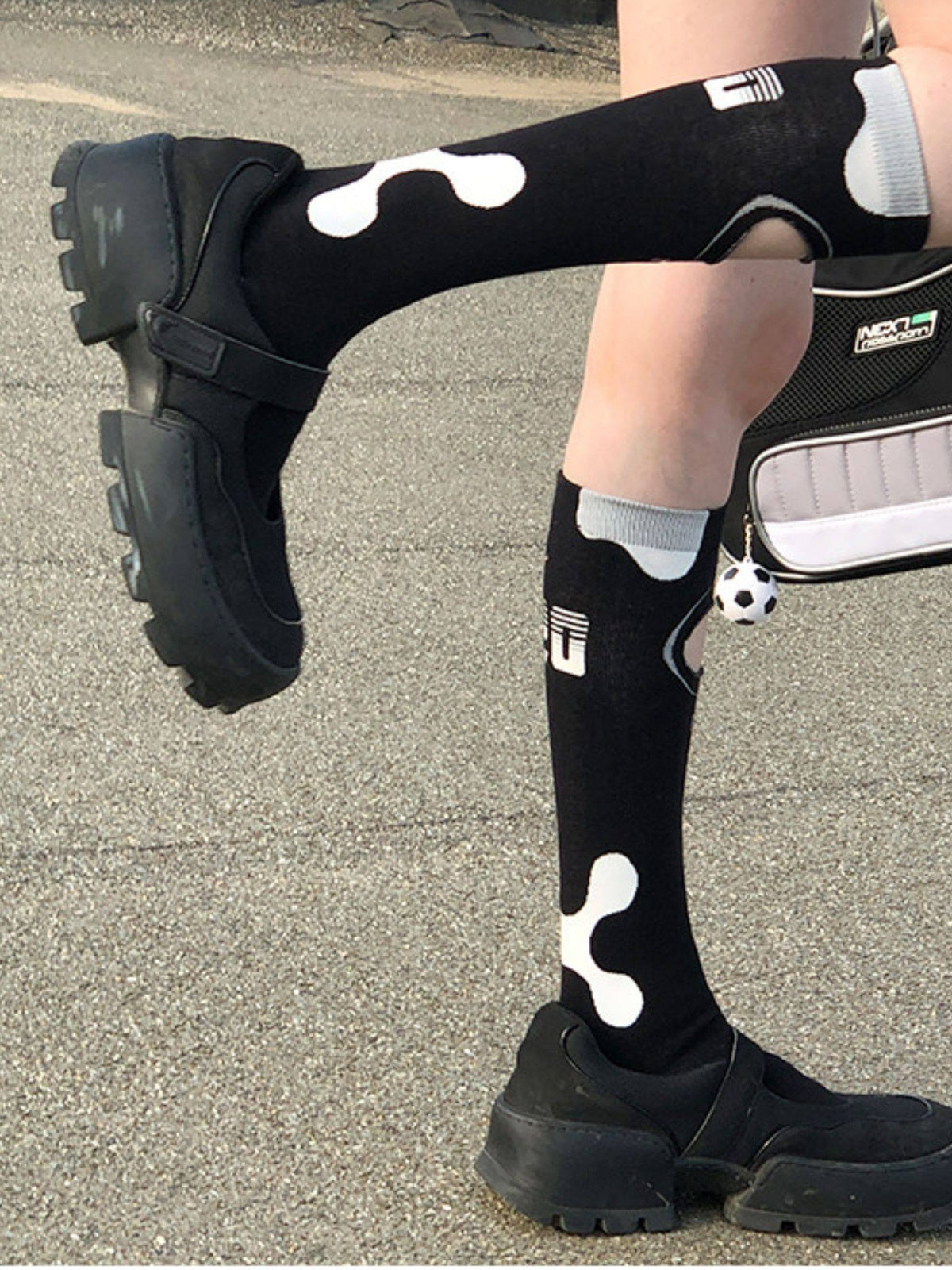 NEXT PASSPORT black openwork athletic knee-high socks modeled from the front