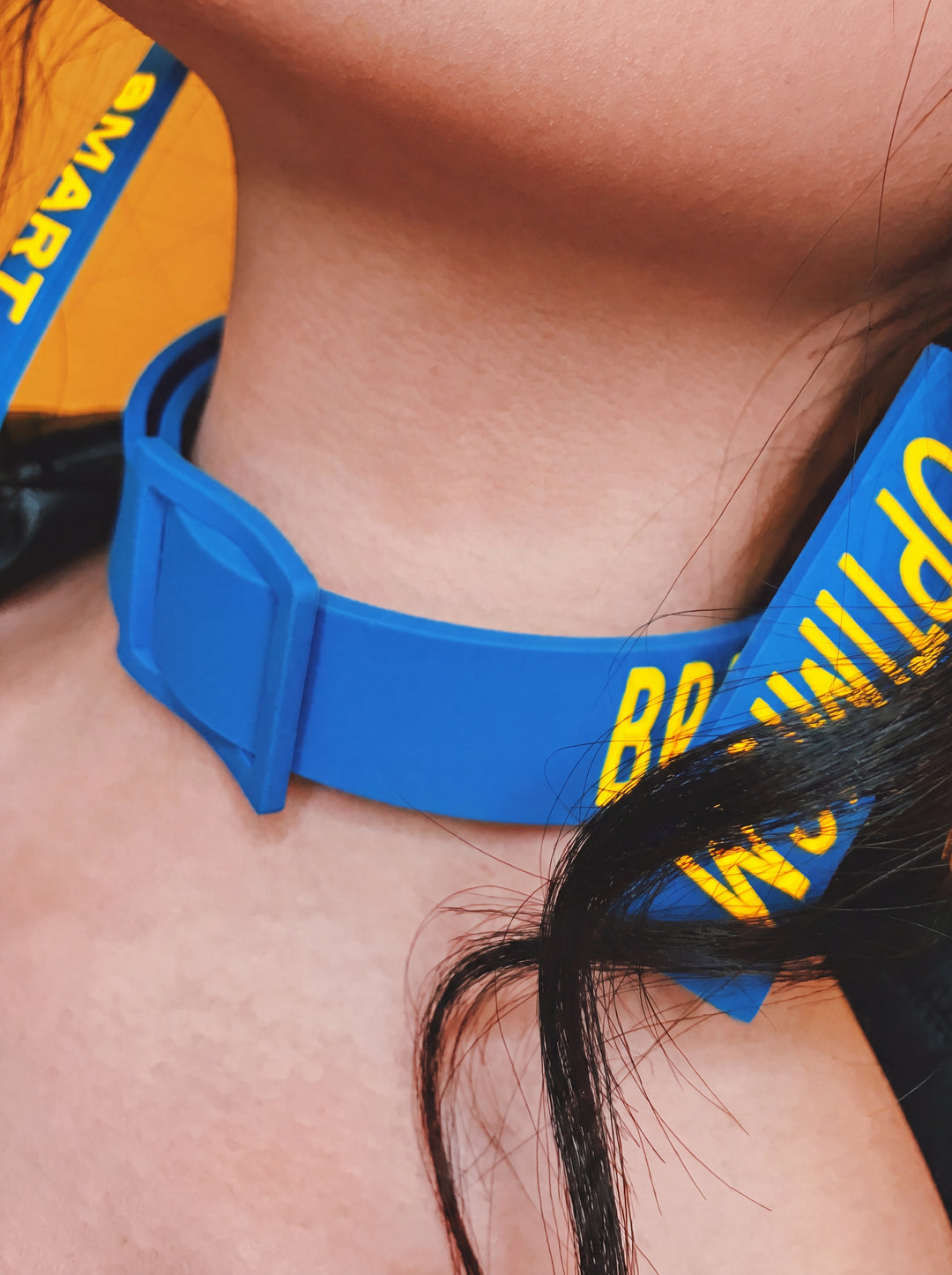 EOH-STUDIO BTBM blue raised-letter silicone choker closure detail in a clean high-resolution studio edit.