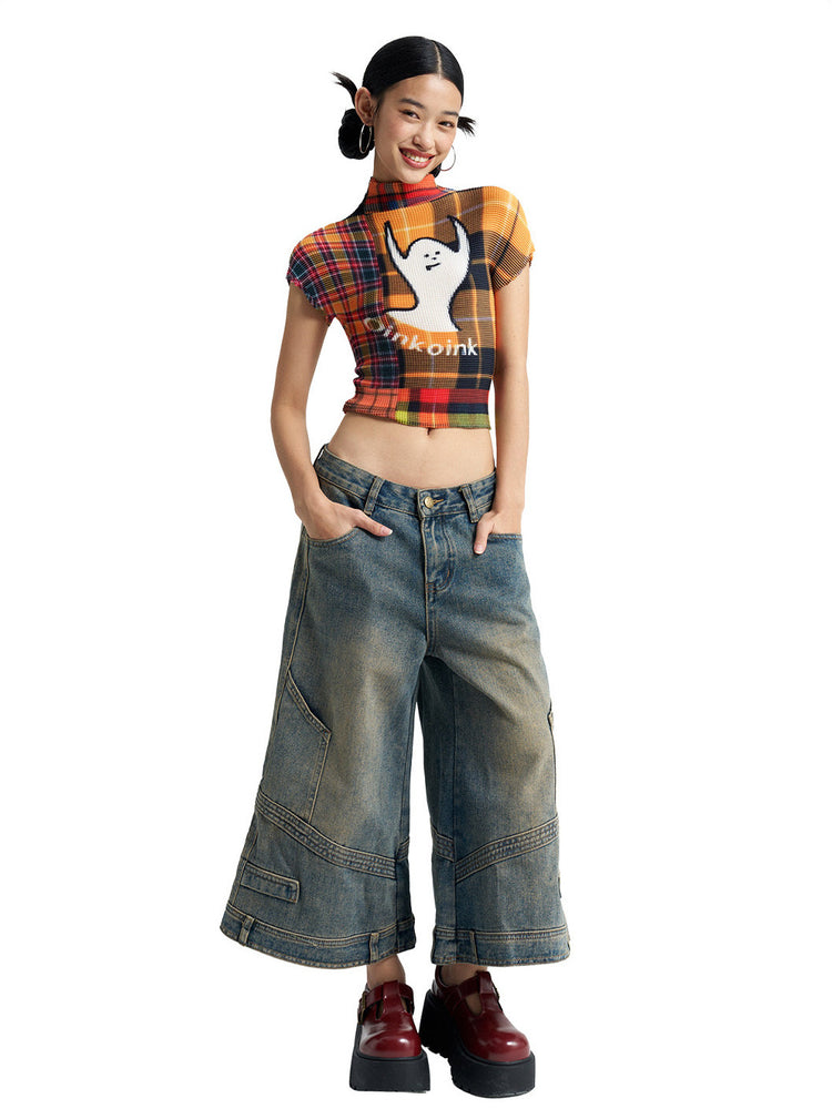 Hands-in-pockets view of NEXT PASSPORT deconstructed wide-leg denim capri pants